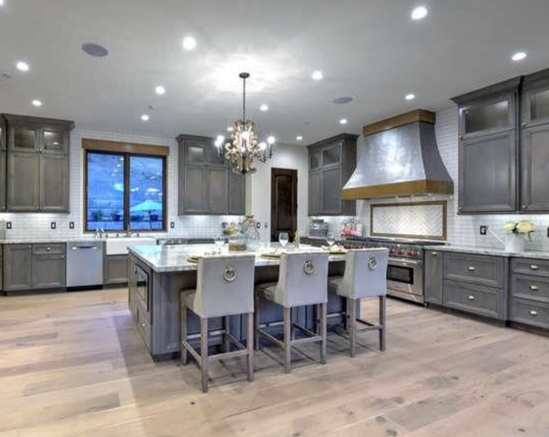 High-end gray transitional kitchen with large island and chandelier