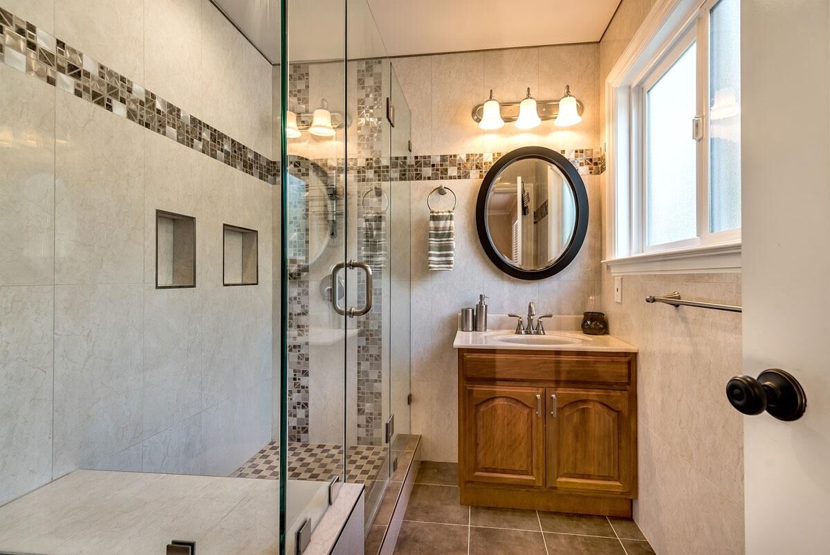 Bathroom remodel with glass shower and mosaic tile detail