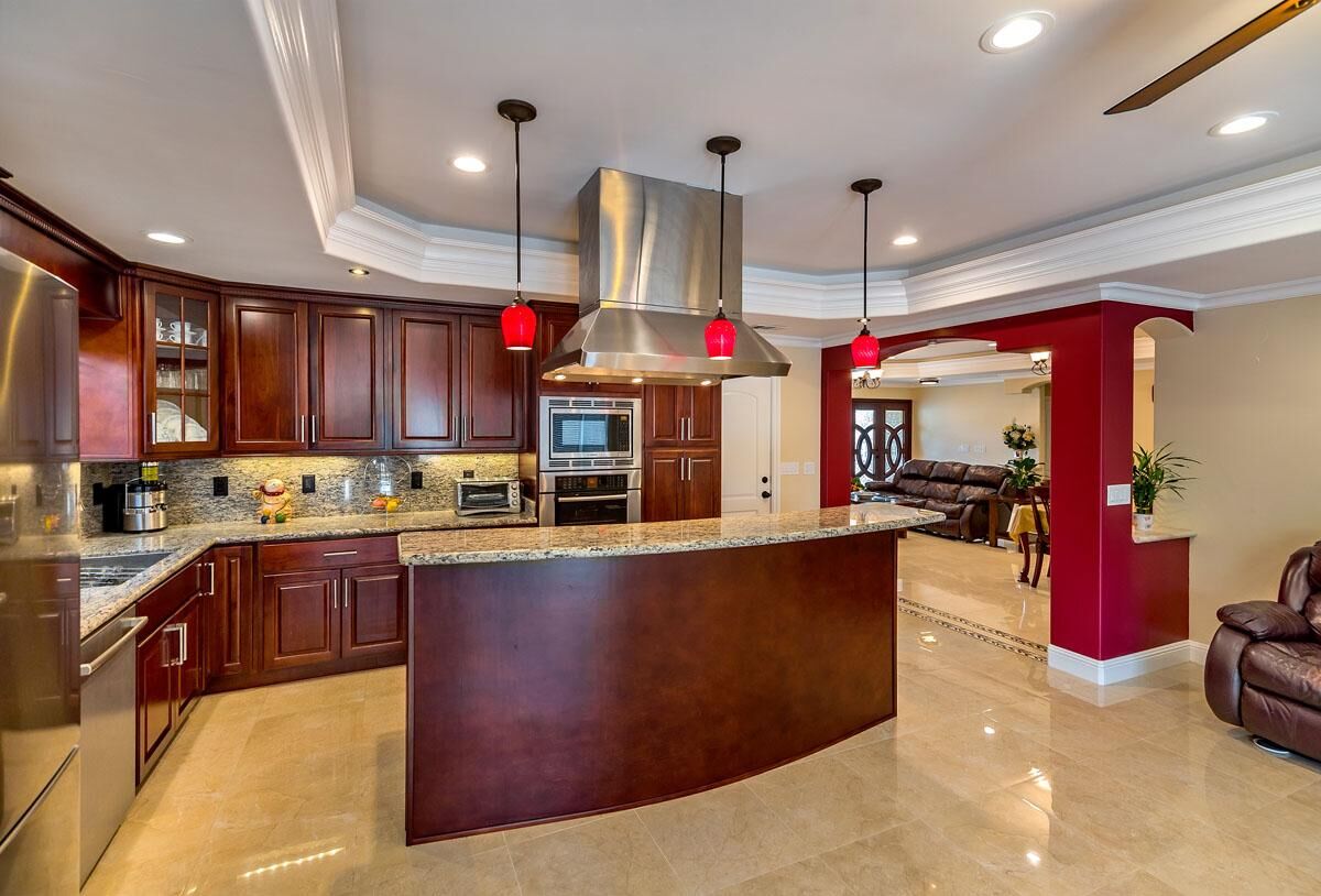 Cherry wood kitchen with island and open-concept living area